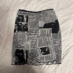 Princess Polly mini skirt with a newspaper type print Photo 0