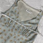 Alyn Paige Long Dress: Elegant 90’s sleeveless dress features A-line silhouette, perfect for any occasion. The delicate fabric drapes beautifully, providing a flattering fit. This timeless piece can be dressed up or down, making it a versatile addition to your wardrobe. Ideal for summer gatherings or evening events, it's a must-have for style enthusiasts. Photo 4