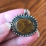Antiqued silver tone pendant with oval shaped variegated brown stone Photo 5