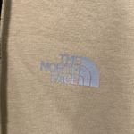 The North Face  women XS hooded sweater tan color with reflective lines Photo 1