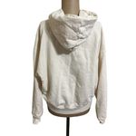 We Wore What  cream hooded sweatshirt with front pocket size Medium Photo 2