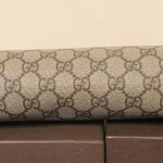 Gucci GG Supreme Clutch with Gold GG Zipper Pulls On Top Close and Front Pocket Photo 5