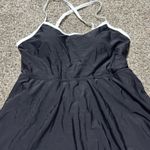 LA Made This chic sundress by Anage features a pleated design in classic black and white, perfect for a casual night out. The sleeveless silhouette with spaghetti straps and a mini length adds a playful touch to your ensemble. Its versatile style makes it a must-have for any wardrobe. Photo 2