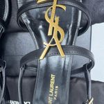 Saint Laurent CASSANDRA LEATHER WITH GOLD EMBLEM HARDWARE IN BLACK SANDALS. Photo 10