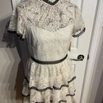 Shoshanna Stacia Lace Tiered Polka Dot Knee Length High Neck Black trim on neck/sleeve/bottom Hidden back zipper A flutter sleeve ballet lace fit-and-flare mini dress with ruffle detail below the waist ivory cream Kentucky Derby mock sheer layer Photo 3