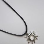 Silver sun with black leather cord Photo 0