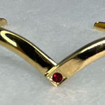 Avon gold tone V shaped cuff bracelet with faux ruby or garnet. Large Photo 0
