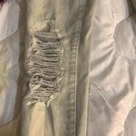 American Eagle Size 00 Super Strechy off white Jeans. Lots of Holes Photo 8