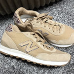 New Balance  515 sneaker in a beige/incense colorway with a leopard print "N" logo and heel tab accent.  Photo 0