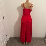 Ellison Stand out in this vibrant red maxi dress. Features stylish cutout patterns. Perfect for beach outings or summer events. Photo 5