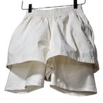 We Wore What NWT Athleisure Layered Windbreaker Biker Shorts in Off White Photo 3
