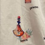 Source Unknown Women’s white cropped Tee - White and Yellow with perfume pattern Photo 1