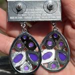 Earrings in shades of purple and silver on a post setting Photo 2