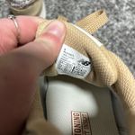 New Balance  515 sneaker in a beige/incense colorway with a leopard print "N" logo and heel tab accent.  Photo 5