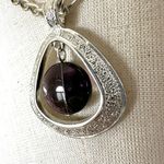é silver tone and purple teardrop pendant necklace Silver Photo 3