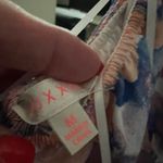 Beginning Boutique Floral Ruffle romper in Purple and Pink Photo 1