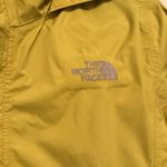 The North Face  lime green rain jacket Photo 1