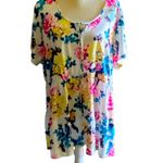 Torrid NWT- Stunning white with bright colorful flowers, babydoll style, ties in front, flutter sleeves, lightweight, the perfect summer top, brand new, size 2x Measurements: Bust: armpit to armpit 25 inches Waist: side to side 22-27 inches Length: shoulder seam to bottom 30 inches Photo 0