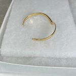 Avon gold tone V shaped cuff bracelet with faux ruby or garnet. Large Photo 3