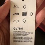 Adidas ADILETTE COMFORT K sandals pink orange super soft comfy light weight NWT New with tag Same day shipping Smoke and pets free Get ready to step up your style with these Adilette Comfort K sandals! These sandals are perfect for those who want to look fashionable while staying comfortable. With a super soft and lightweight design, these sandals are perfect for all-day wear. The pink and orange striped pattern adds a pop of color to your outfit, making them a great choice for any occasion. These sandals come in a UK shoe size 5, US shoe size 5, and EU shoe size 37. The synthetic upper material and comfort slide product line ensure that your feet will stay cool and comfortable no matter where you go. Don't miss out on the chance to add these stylish and comfortable sandals to your shoe collection! Photo 5