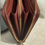 Coach Accordion Zip Wallet in a Plum color with gold tone hardware. Photo 8