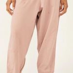 Free People movement dusty rose colored joggers with ankle zip and drawstring Photo 0