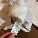 crewneck with cut out neck size small / medium The beige is more jagged cut but it's so soft!! White Photo 3