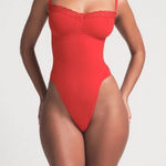 SKIMS Seamless Sculpt Lace Thong Bodysuit Photo 0