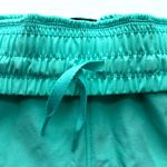 Under Armour Women’s Under Armor Flex Woven 5” Loose Fit Pocket Shorts Light Teal Size L NWT Photo 6