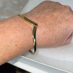 Avon gold tone V shaped cuff bracelet with faux ruby or garnet. Large Photo 6