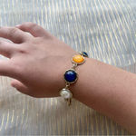 Multicolor bracelet orange, blue and white with gold Photo 0