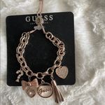 Guess Gold Charm Bracelet with Heart and Logo Charms Photo 0