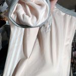 Adidas Light Pink White Stripes Gray collar Long Sleeve Full Zip Fleece Hoodie Jacket Zip Up Jumper New with tag Same day shipping Smoke and pets free Elevate your activewear game with this stylish hoodie. The light pink and white stripes, gray collar, and colorful logo make it a fashionable choice for any casual occasion. The full zip and pockets make it practical for everyday wear, while the fleece fabric ensures comfort and warmth. Featuring long sleeves, accented with straps, and a collared neckline, this hoodie is perfect for those chilly days. The XL size is appropriate for regular-sized women. With a striped pattern, full zip, and logo theme, this hoodie makes a great addition to any sportswear collection. Photo 2