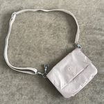 Kipling crossbody purse. Adjustable strap. Flap over closure w/ snap. Light pink Photo 0
