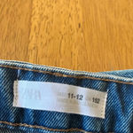ZARA denim mini skirt, size 11/12. It is slightly distressed with a raw hem. Photo 4