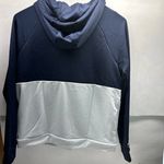 Under Armour Terry Fleece Blocked Hoodie With Hat Navy Blue White Gray Sz XS NWT  New with tag  Same day shipping  Smoke and pets free  This  hoodie is perfect for anyone looking for a comfortable and stylish addition to their wardrobe. With a navy blue, white, and gray color-blocked design and forest green and halo gray accents, this hoodie is sure to stand out. It features a hood and long sleeves, making it perfect for all seasons. The polyester material is breathable and durable, ensuring that it will last for years to come. The XS size is perfect for both men and women, with a regular fit that is comfortable and flattering. This hoodie is great for casual wear or for working out, and the fleece fabric provides added warmth on cooler days. Photo 1