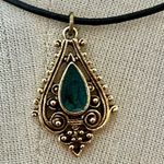Green and gold tone pendant necklace on black cord Photo 1