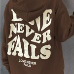 SheIn  Brown Hoodie with 'Love Never Fails' Graphic Photo 2