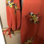 Francesca's Francesca’s Miami Floral Long Sleeve Faux Wrap Jumpsuit Orange Medium Photo 7