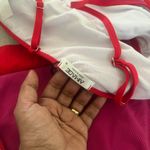 Make a splash with this vibrant pink bikini set. Perfect for a day at the beach or lounging by the pool. Photo 6