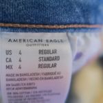 American Eagle Outfitters next level stretch super hi-rise flare jeans in medium wash blue size 4. Photo 14