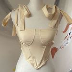 Cider  bandeau.  Size Small. Zip closure on side. Straps tie into bows. Photo 0