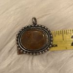 Antiqued silver tone pendant with oval shaped variegated brown stone Photo 7