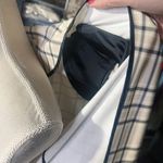 Calvin Klein $159 checkered long Cardigan cream jacket leather pockets long sleeve leather cuff adjustable waist tie padded shoulder size 4 NWT New with tag Same day shipping Smoke and pets free Elevate your winter wardrobe with this stunning checkered cardigan jacket. Crafted with high-quality polyester, this long overcoat comes with leather pockets for added convenience. The jacket boasts a unique check pattern that is sure to turn heads wherever you go. This padded jacket is perfect for cold winter nights and comes with a strap accent that adds a touch of sophistication to the overall design. Available in size 4, this jacket is perfect for women who prefer a regular fit. Don't miss out on this must-have cold weather essential! Photo 9