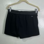 Adidas , athletic mini shorts, women’s size small, logo graphic Photo 1
