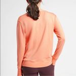 Athleta NWT  Sunrise V neck Sweatshirt Medium peachy orange color thumb holes Photo 1