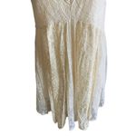 Free People -DONT YOU DARE Stunning cream color lace dress, sleeveless, lined, front keyhole opening, V back, skirt has some gold shimmer, excellent condition, size XS Measurements: Bust: armpit to armpit 15 inches Length: shoulder seam to bottom 33 inches Photo 6