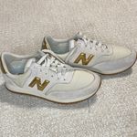 New Balance  Women's Cream and Gold Athletic Shoes Photo 1