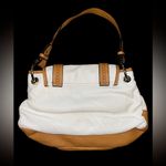 Franco Sarto  tan and cream saddle style bag. Has a tear in the pocket inside Photo 2