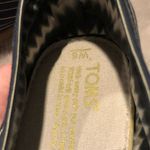 Toms  slipons in navy blue and tan stripes with “Love Is the New Black” quote Photo 3